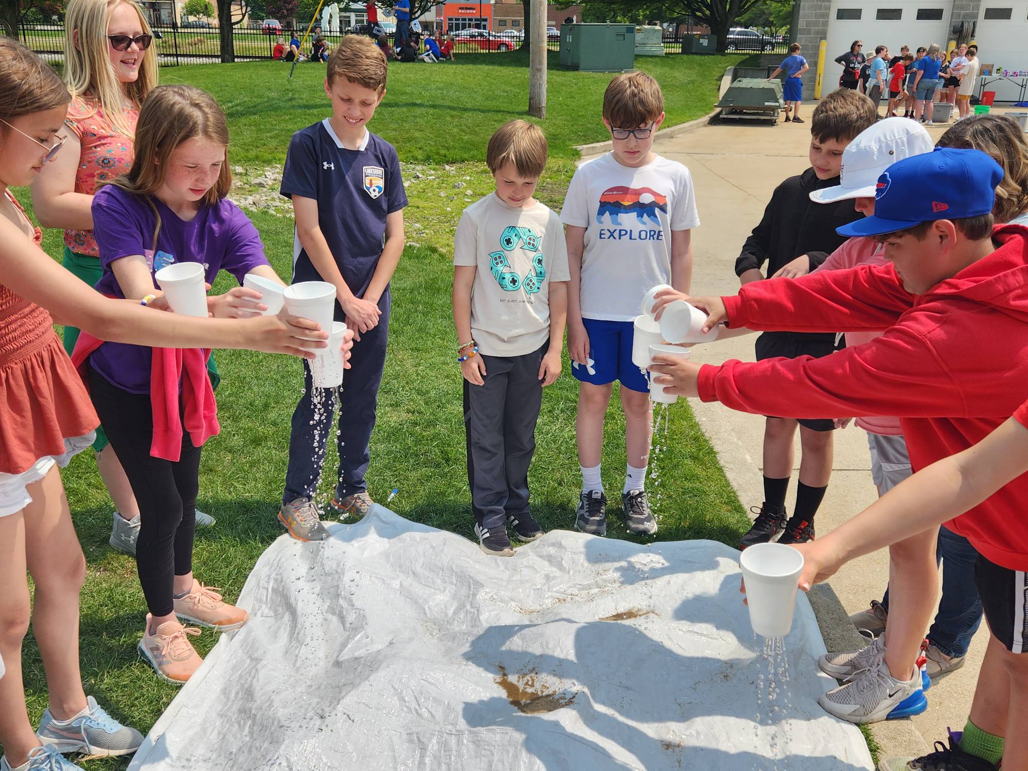 Students simulate a rainstorm over a model of a watershed during an AWRI landside program